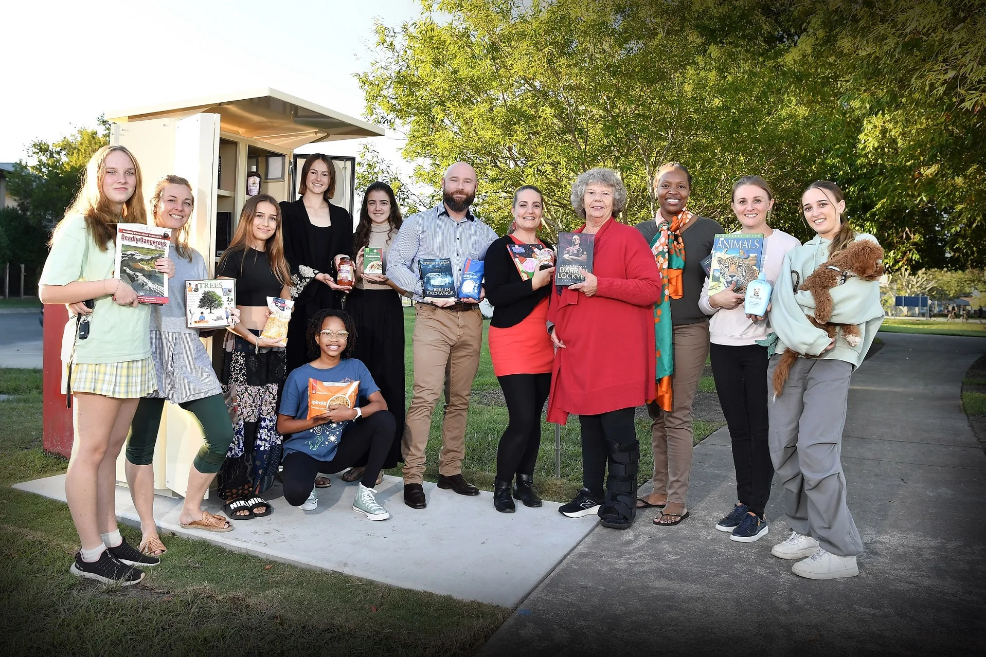 Members of the Eaton Park Community Group join Cr Christian Dickson at their new community pantry.